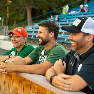 Photo of John McVay and two other people watching a baseball game